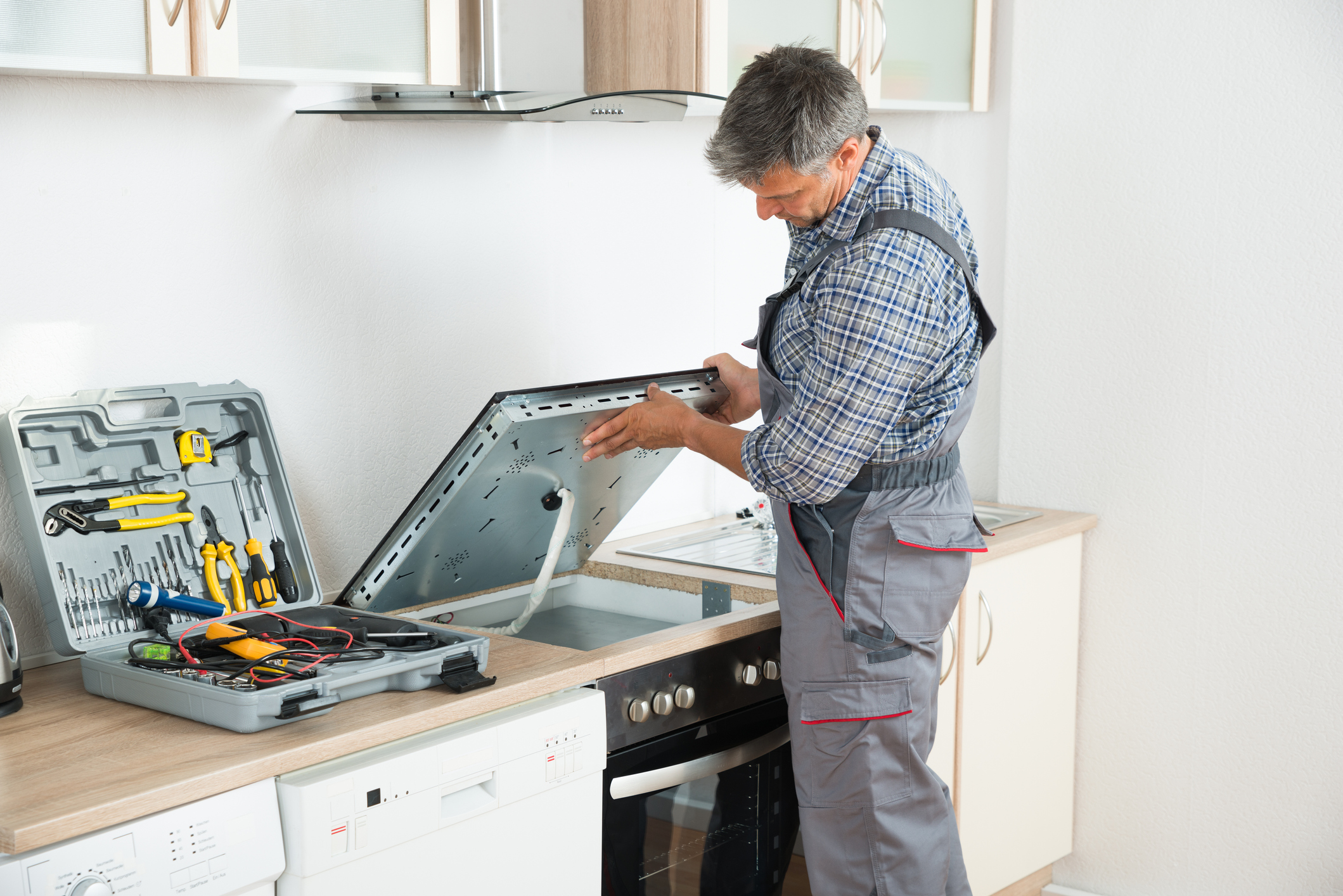 Repairman Examining Stove