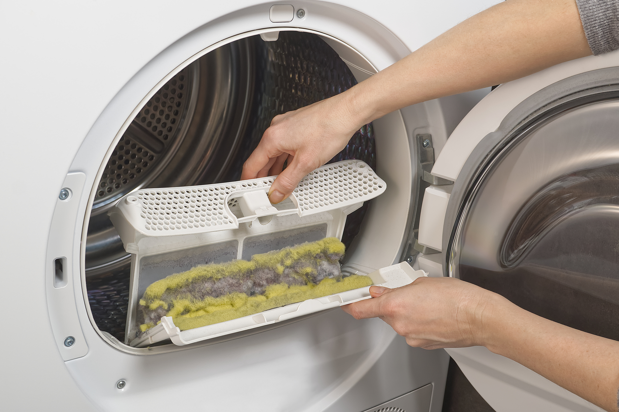 a person cleaning their dryer vent